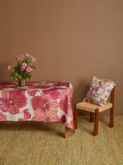 Side view of Wild Pansy Pink Tablecloth draped over table edge showing full pattern coverage