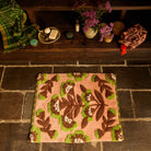 Carnelian Winona Bath Mat styled on stone floor below a wooden shelf with bathroom accessories