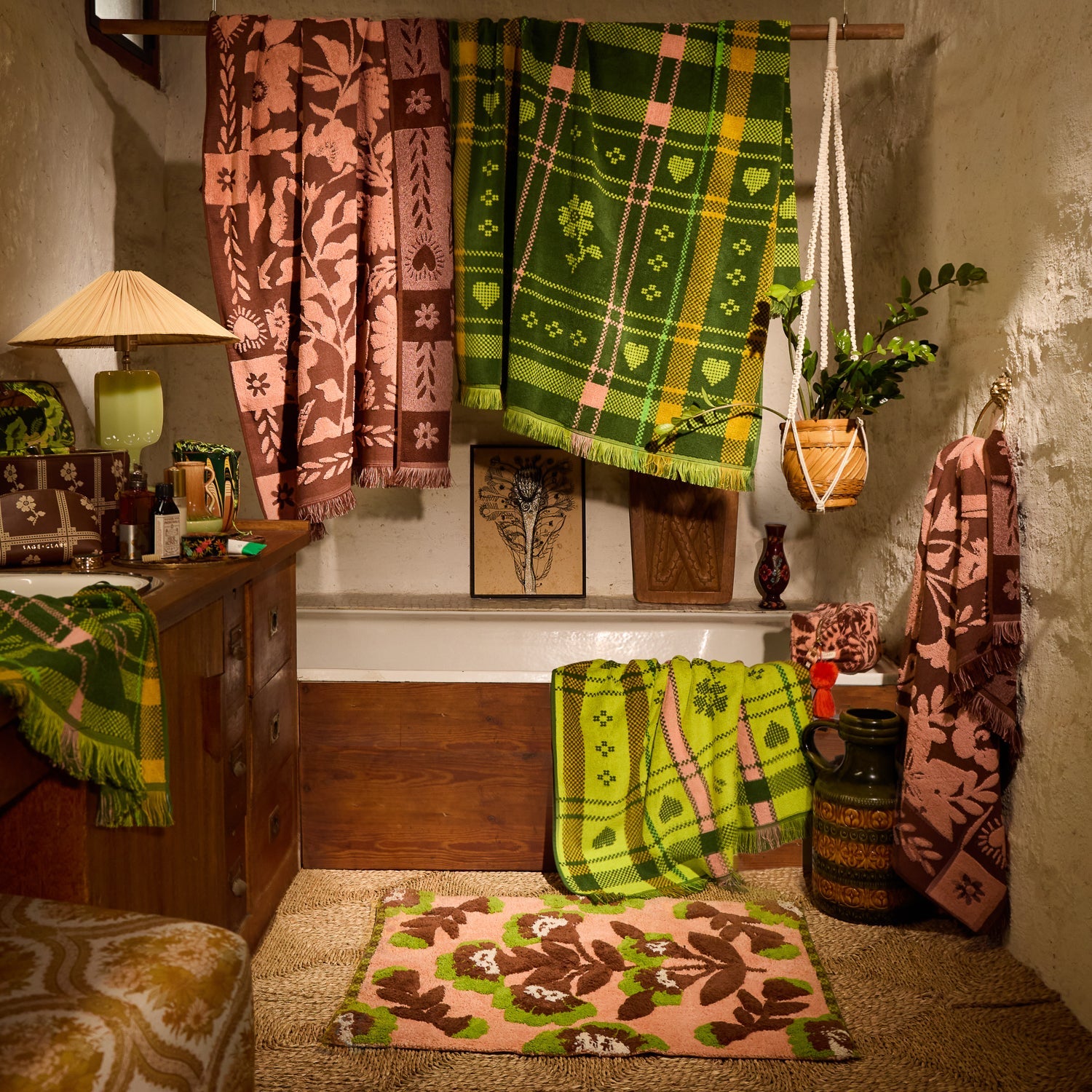 Carnelian Winona Bath Mat on a jute rug in a styled bathroom vignette surrounded by coordinating towels and accessories