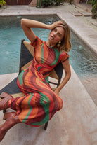 Lifestyle shot of Yoko Midi Dress showing flowing swirl pattern and comfortable midi length