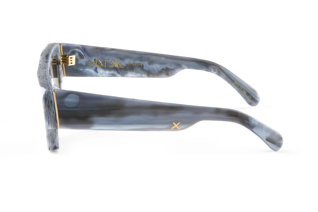 Pair of sunglasses with a marbled gray frame on a white background by Oscar Frank