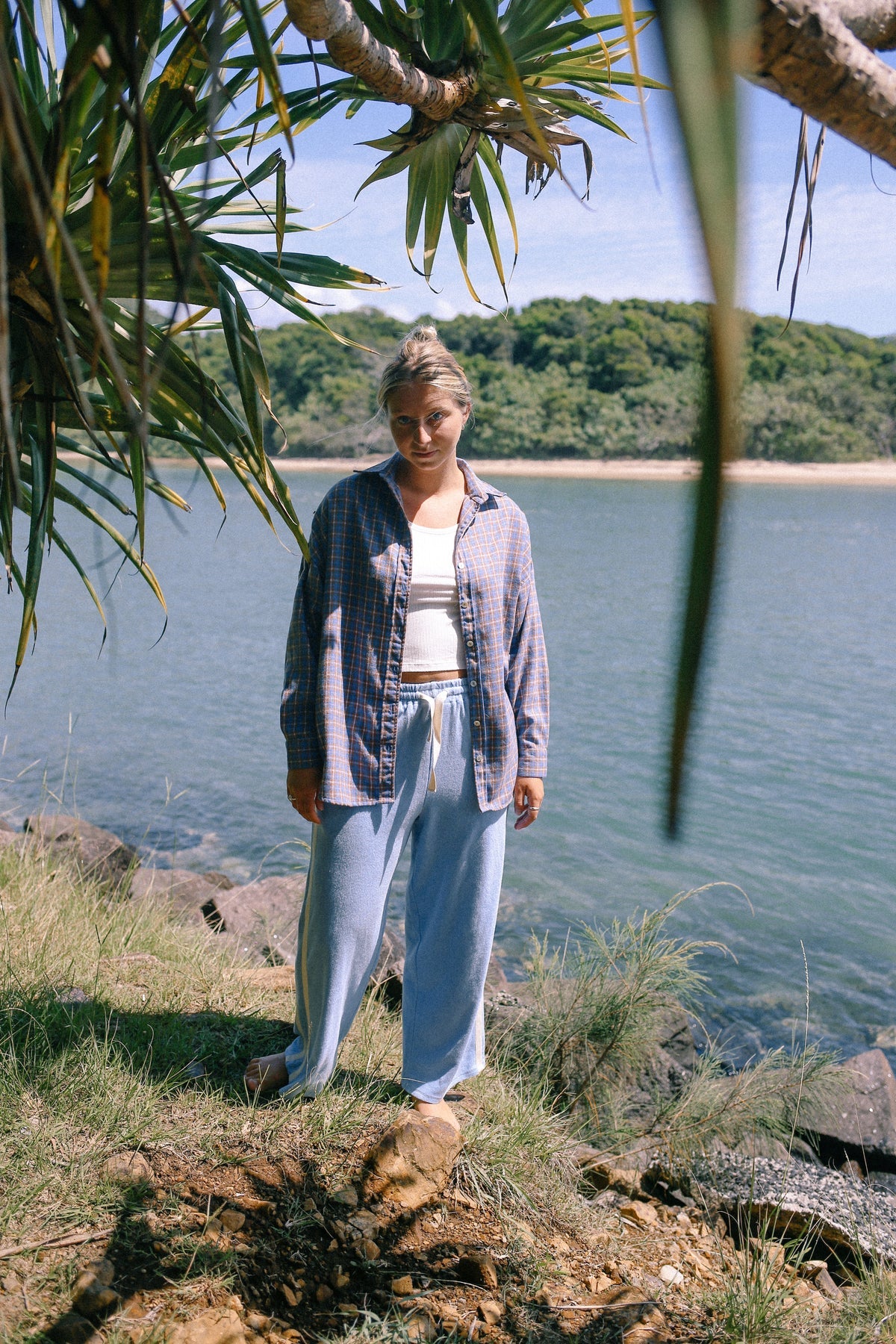 Model wearing 100% cotton terry towelling pants in light blue with white stripe by Atmosea