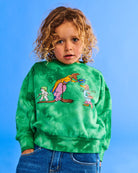 Young boy wearing green sweater featuring May Gibbs prints