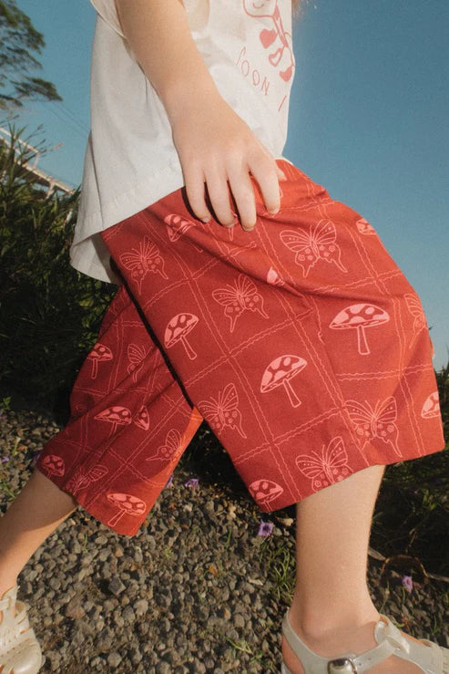child wearing red Mushroom Pants by brand Sauce Mini