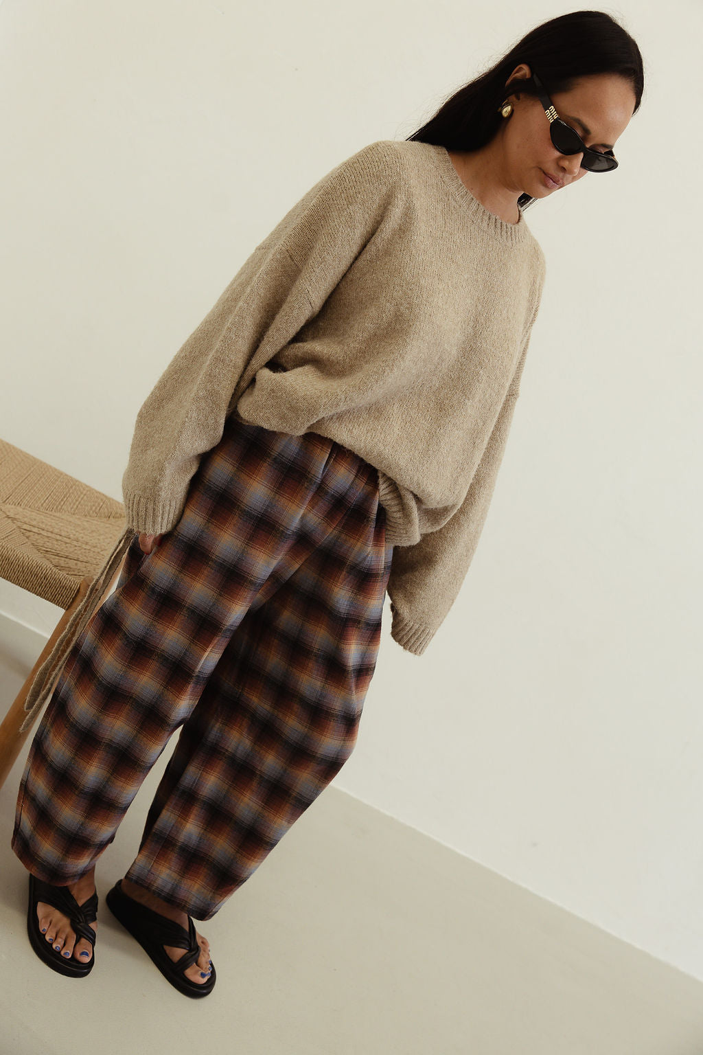 Front angled view showing Vali check pants brown blue plaid design with loose comfortable fit