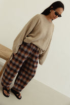 Front angled view showing Vali check pants brown blue plaid design with loose comfortable fit