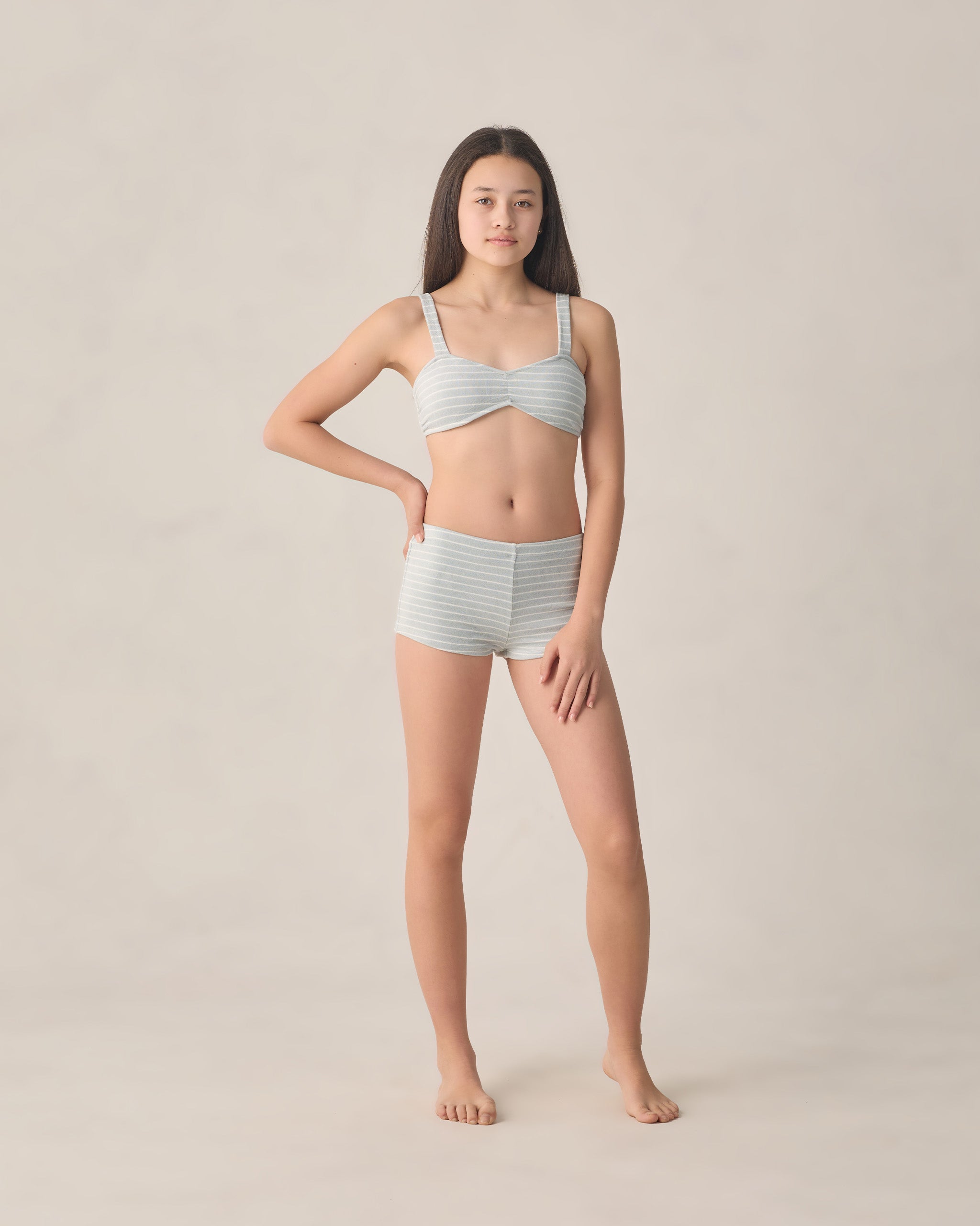 teen girl wearing boyleg bikini with blue and white stripes