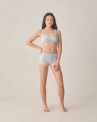 teen girl wearing boyleg bikini with blue and white stripes