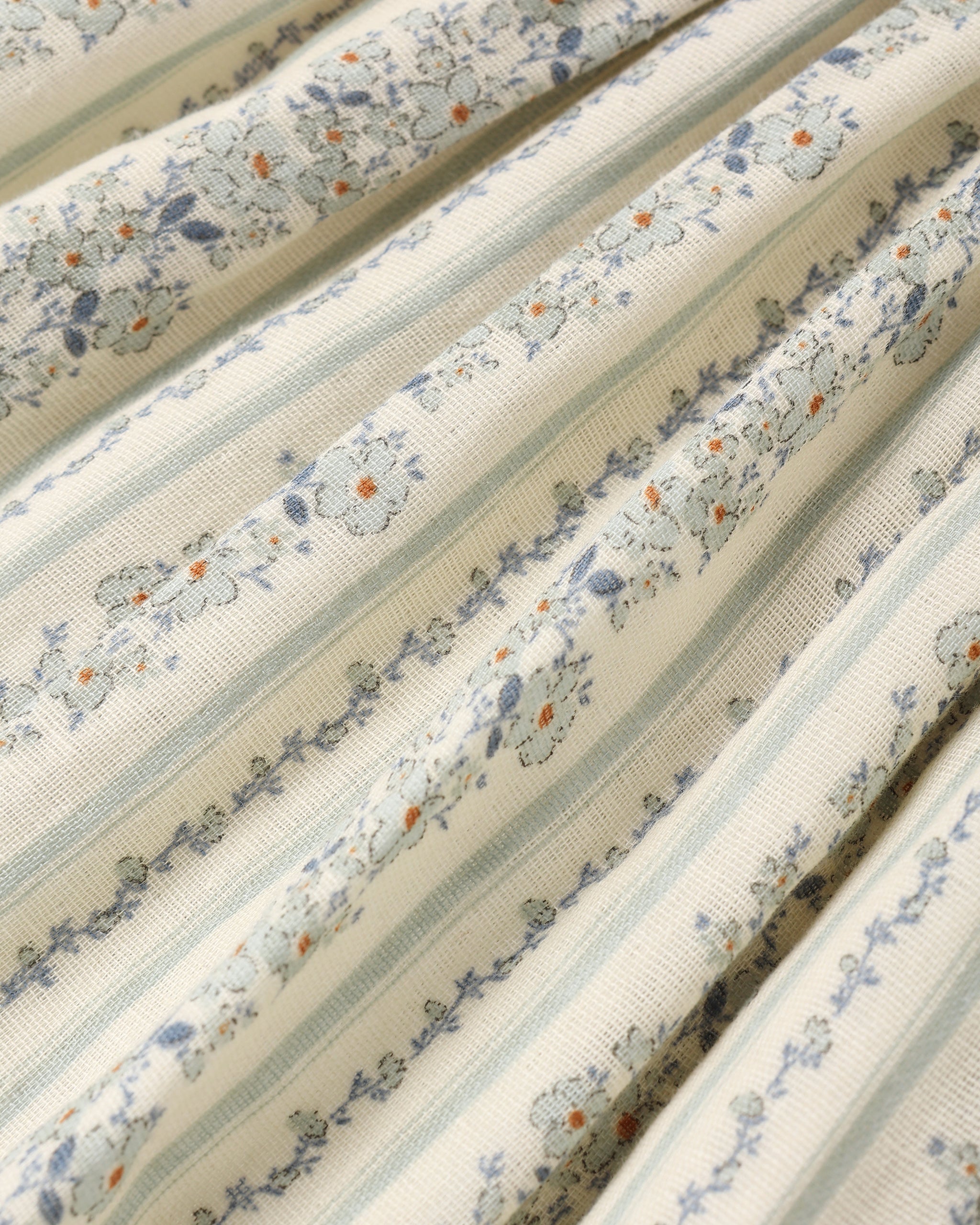 fabric detail of girl wearing Teen Daria Mini Dress Blue Floral by Rylee + Cru
