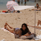 Compact white and beige beach umbrella for solo travellers